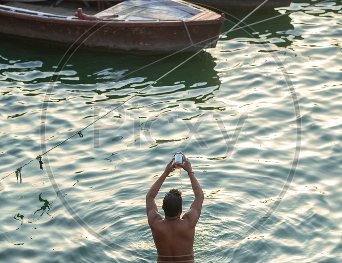 A Devotee Doing  Morning Pooja  To the River Ganga in Varanasi