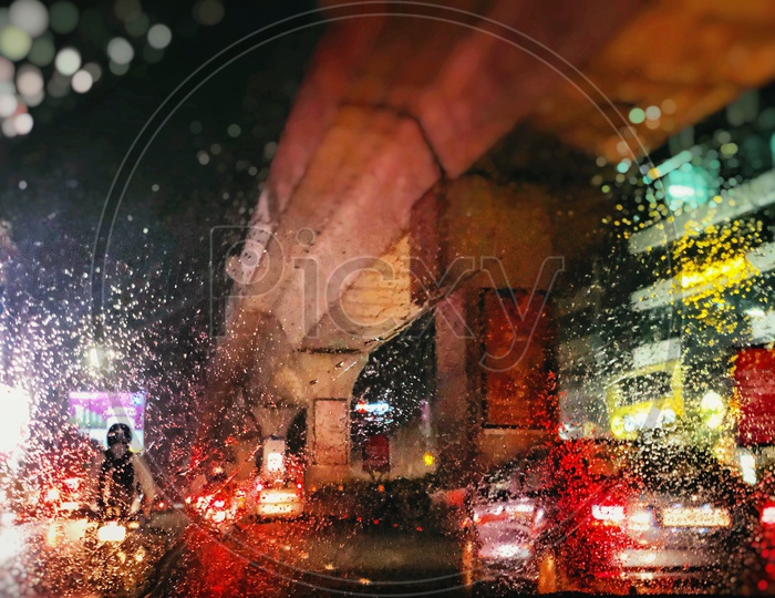 A View Of Metro Pillars Through Car Glass With Rain Water Droplets