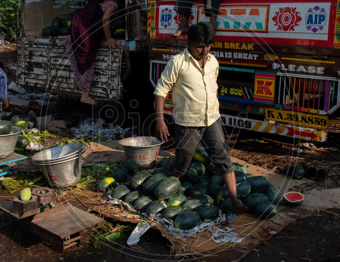 Image of Workers carrying the mango baskets at Kothapet Fruit market