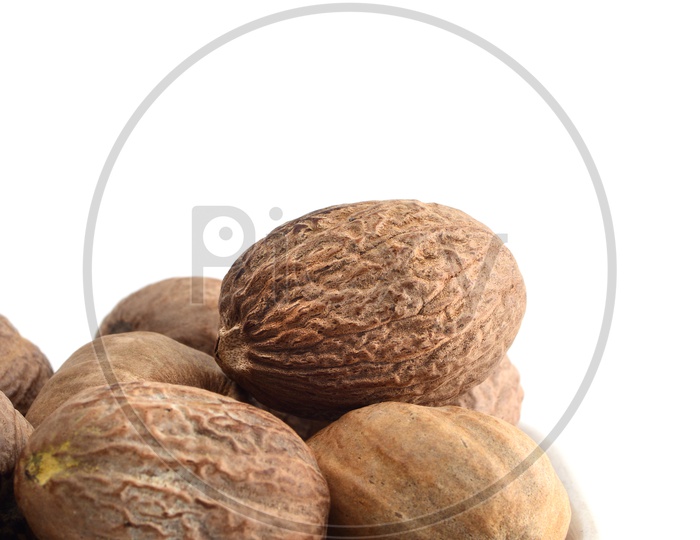 Indian Spice Nutmeg In a White Plate On an Isolated White Background