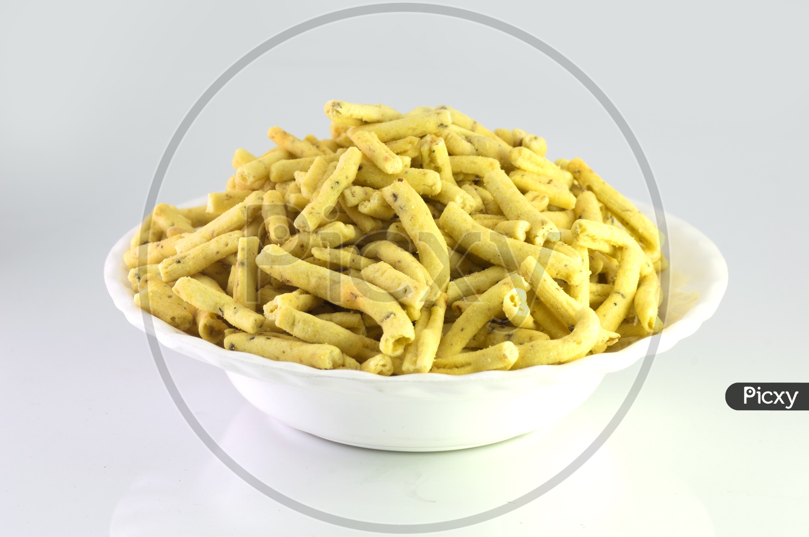 Indian Snack Methi Sev  In an White Bowl  On an Isolated White Background