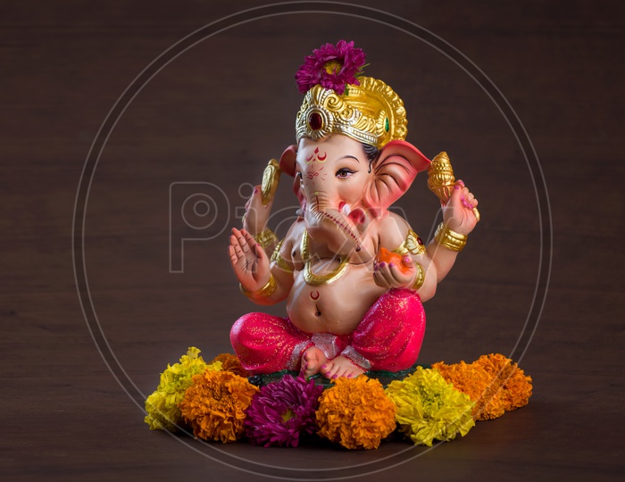 Indian Hindu God, Lord Ganesh Idol For  Pooja For Ganesh Chathurdhi  On an Isolated Black Background