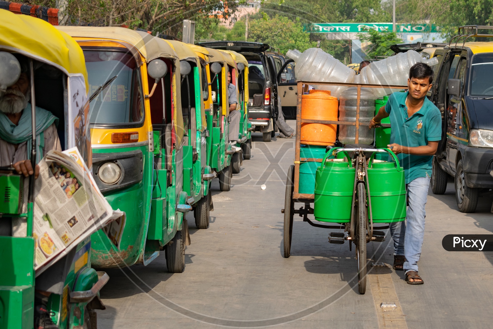 Man carrying water campers in a rickshaw