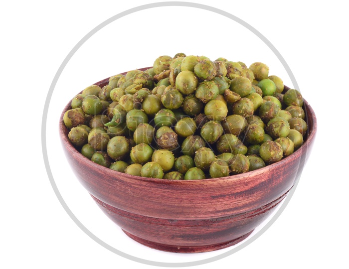 Indian Salty Deep Fried Green Peas  In a Wooden Bowl On an Isolated White Background