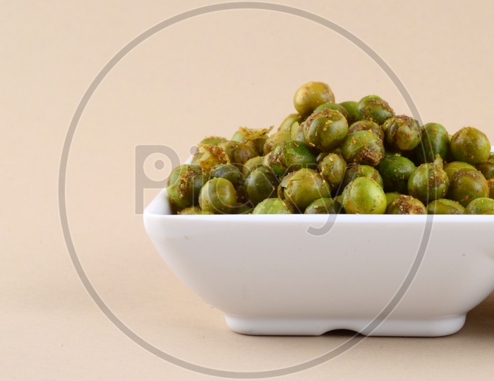 Indian Spiced Deep Fried Green Peas Or Chatpat Matar  in a Bowl  On an Isolated Background