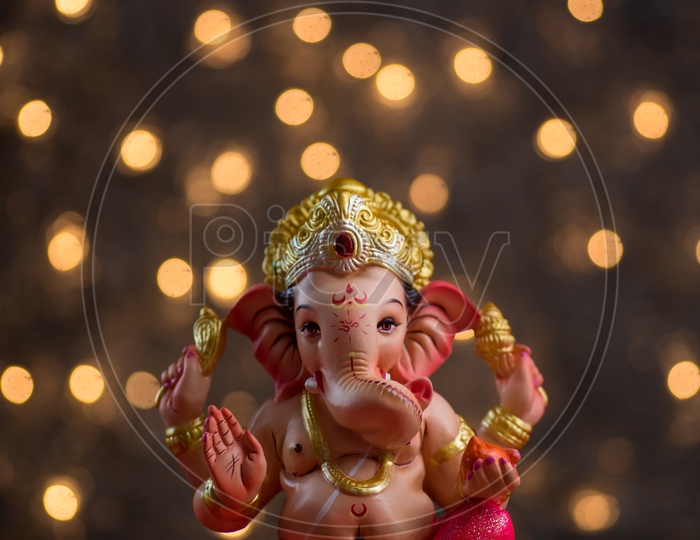 Indian Hindu God, Lord Ganesh Idol For  Pooja For Ganesh Chathurdhi  On an Isolated Led Light Bokeh  Background