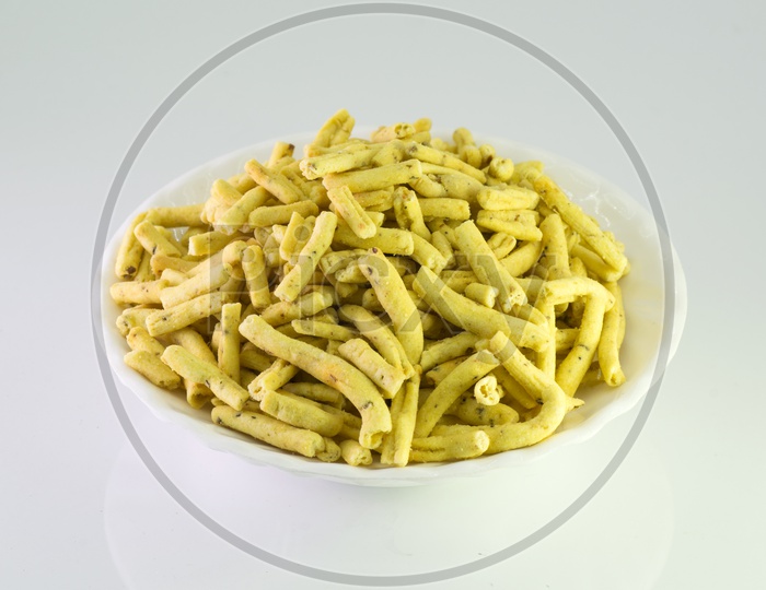 Indian Snack Methi Sev  In an White Bowl  On an Isolated White Background
