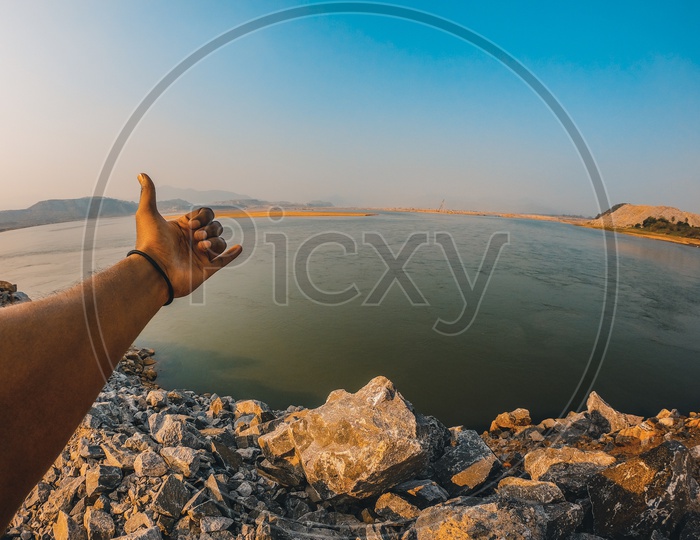 A Man making a sign with his hand by the Polavaram