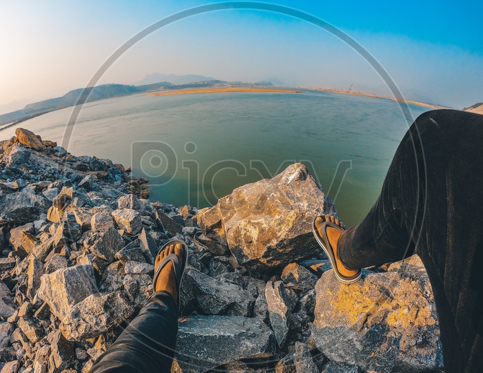 A Man sitting on the rocks alongside the Polavaram