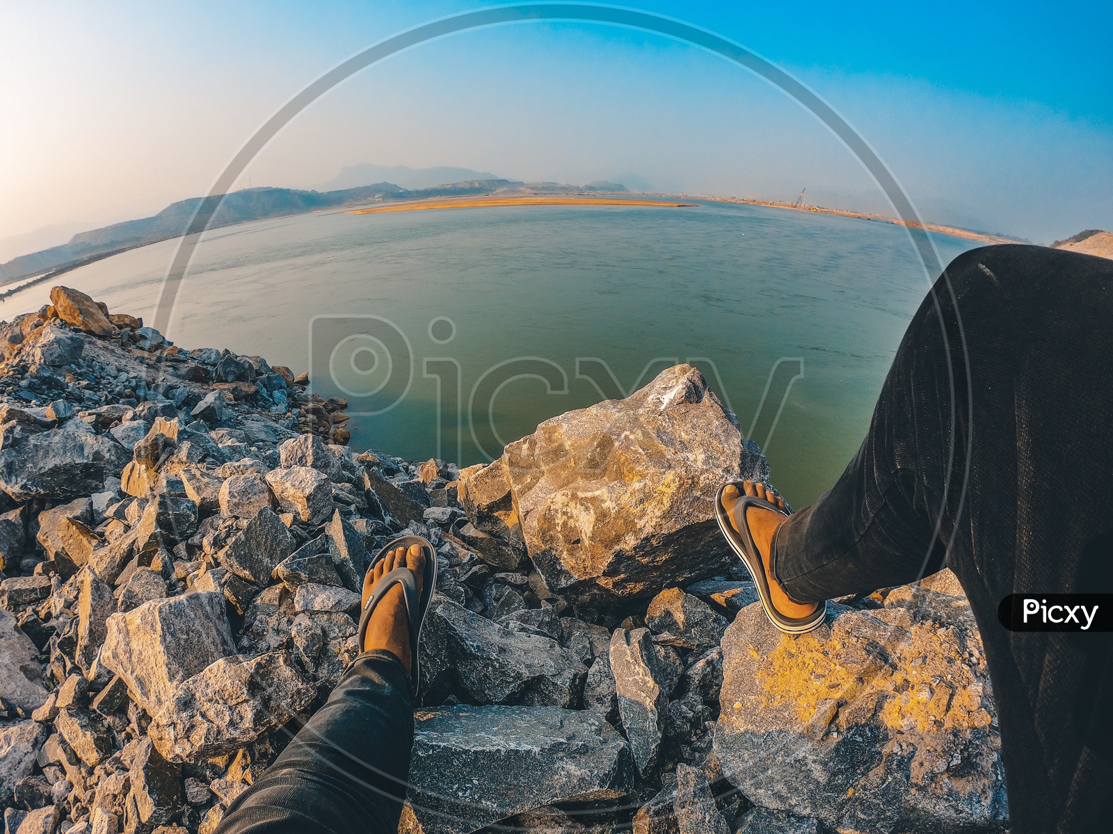 A Man sitting on the rocks alongside the Polavaram