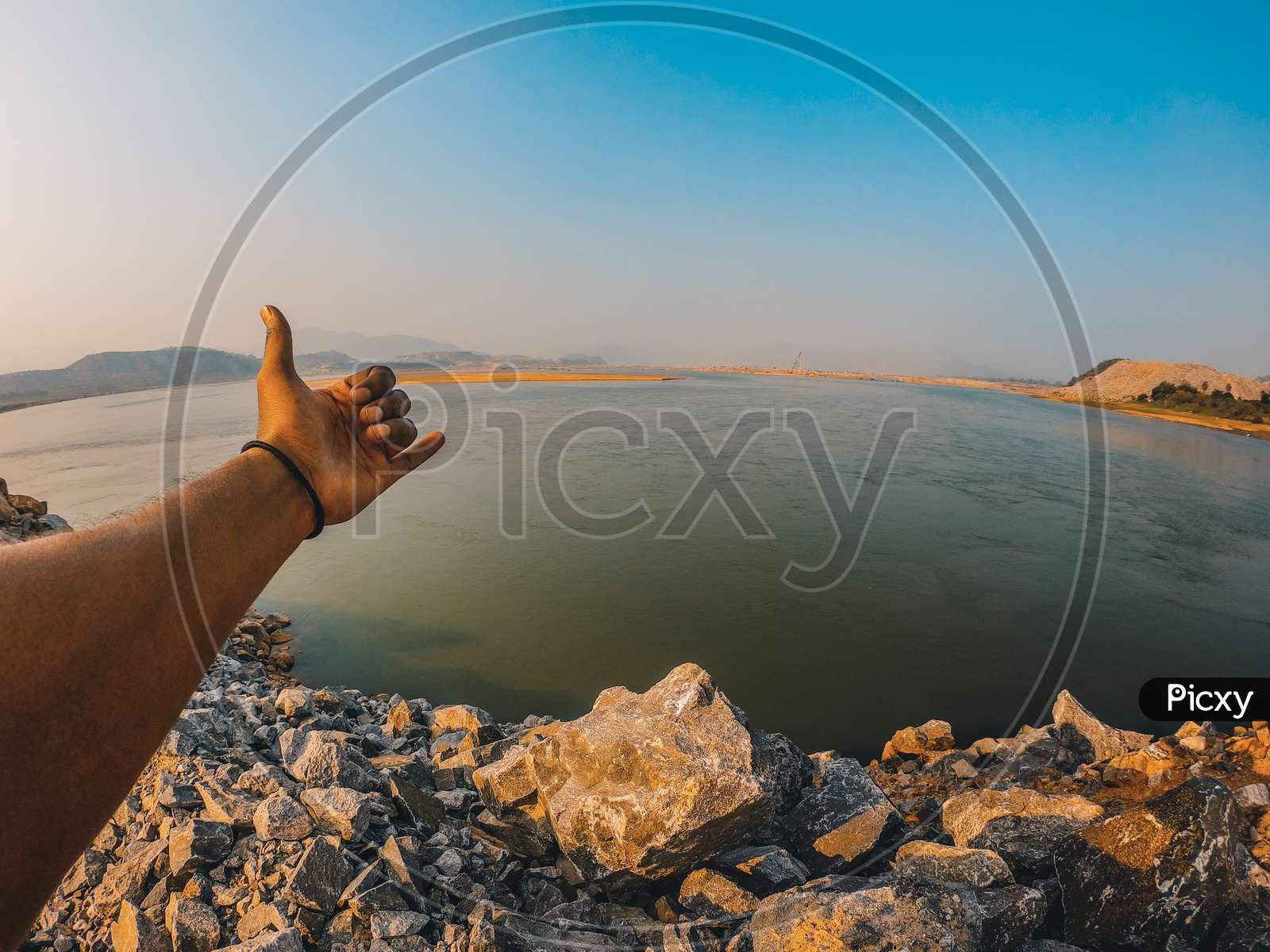 A Man making a sign with his hand by the Polavaram