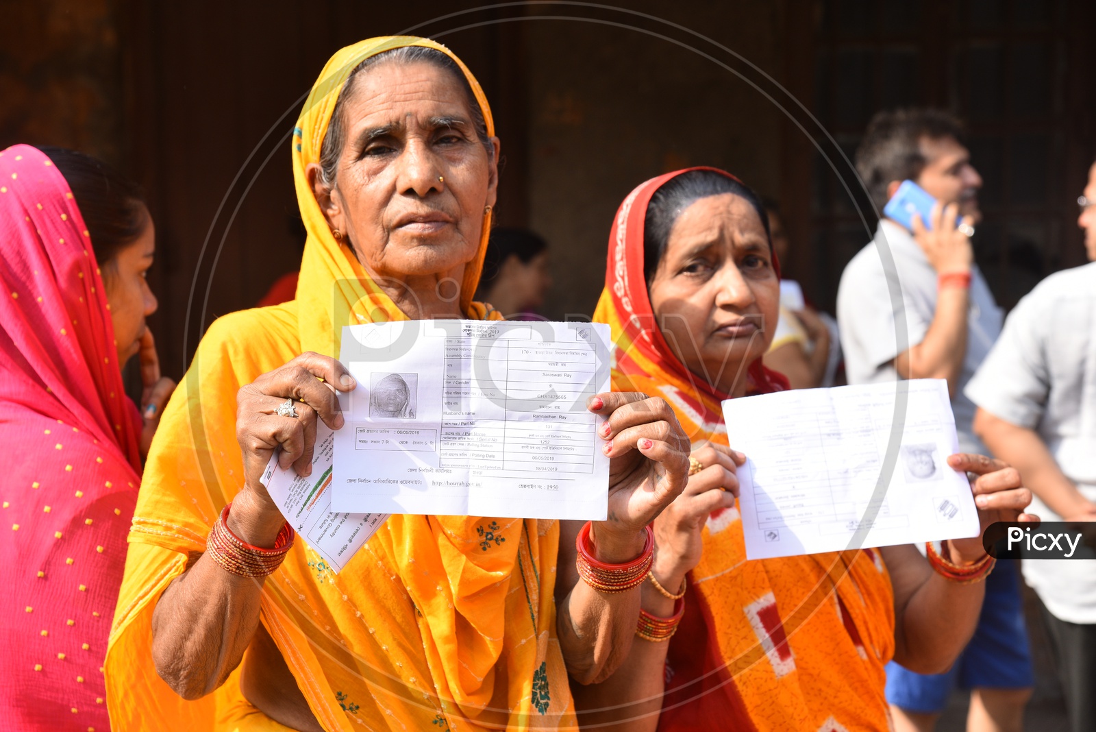 An Indian Old Woman Showing Their EPIC  Voter Cards By Standing In Queue Lines   In Lok Sabha  General Election  2019  in West Bengal