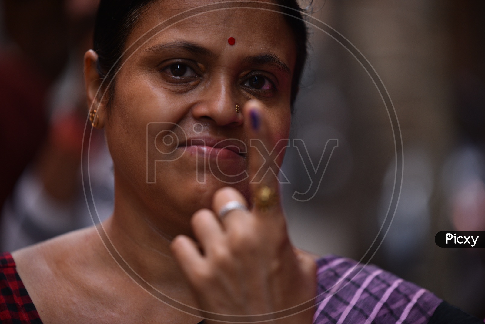 Indian Woman Showing Inked Finger After Casting Her Vote In Parliament General Elections 2019 in West Bengal