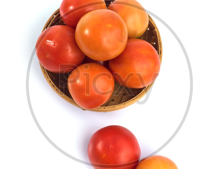 Fresh Red Tomatoes  Vegetable in a Wooden Weaved Basket On an Isolated White Background