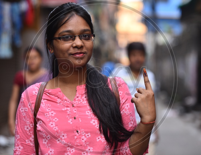 Image Of An Indian Woman Showing Inked Finger After Casting Her Vote In 