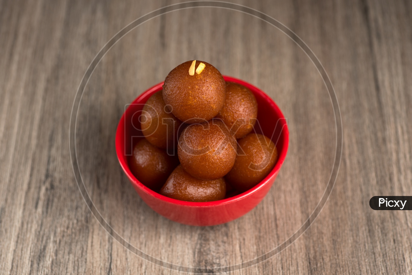 Indian Sweet or Dessert or Savoury Gulab Jamun  in a Bowl On an Isolated Wooden  Background