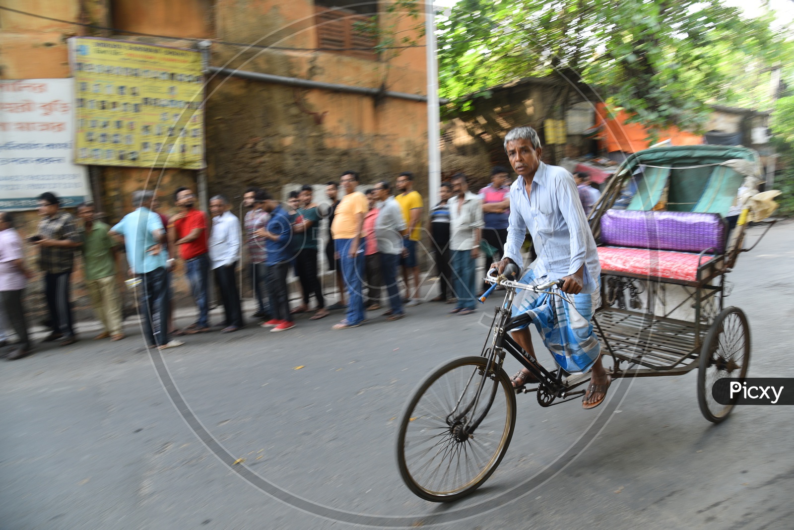 An Old Man  Riding A Rickshaw  on The Roads