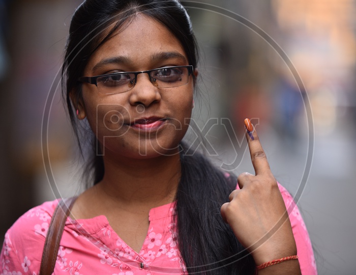Image Of An Indian Woman Showing Inked Finger After Casting Her Vote In 