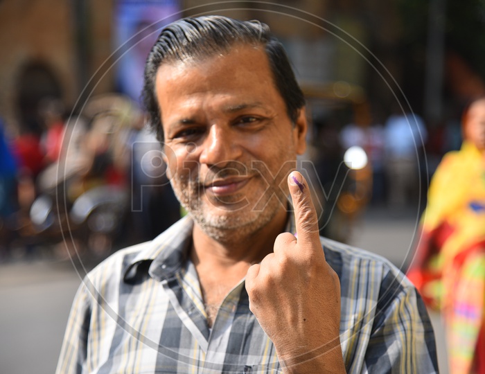 A Middle Age Man Showing His Inked Finger After Casting  His Vote  in General Elections 2019  in West Bengal