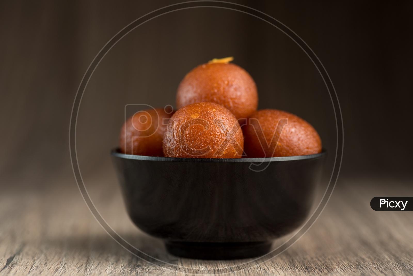 Indian Sweet or Dessert or Savoury Gulab Jamun  in a Bowl On an Wooden Background
