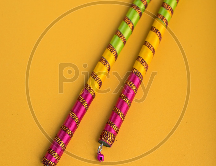Dandiya  Sticks On An Isolated Yellow Background