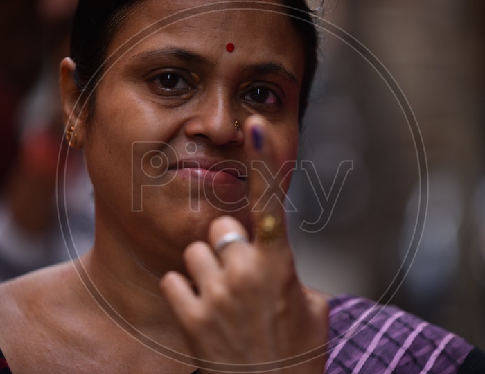Indian Woman Showing Inked Finger After Casting Her Vote In Parliament General Elections 2019 in West Bengal