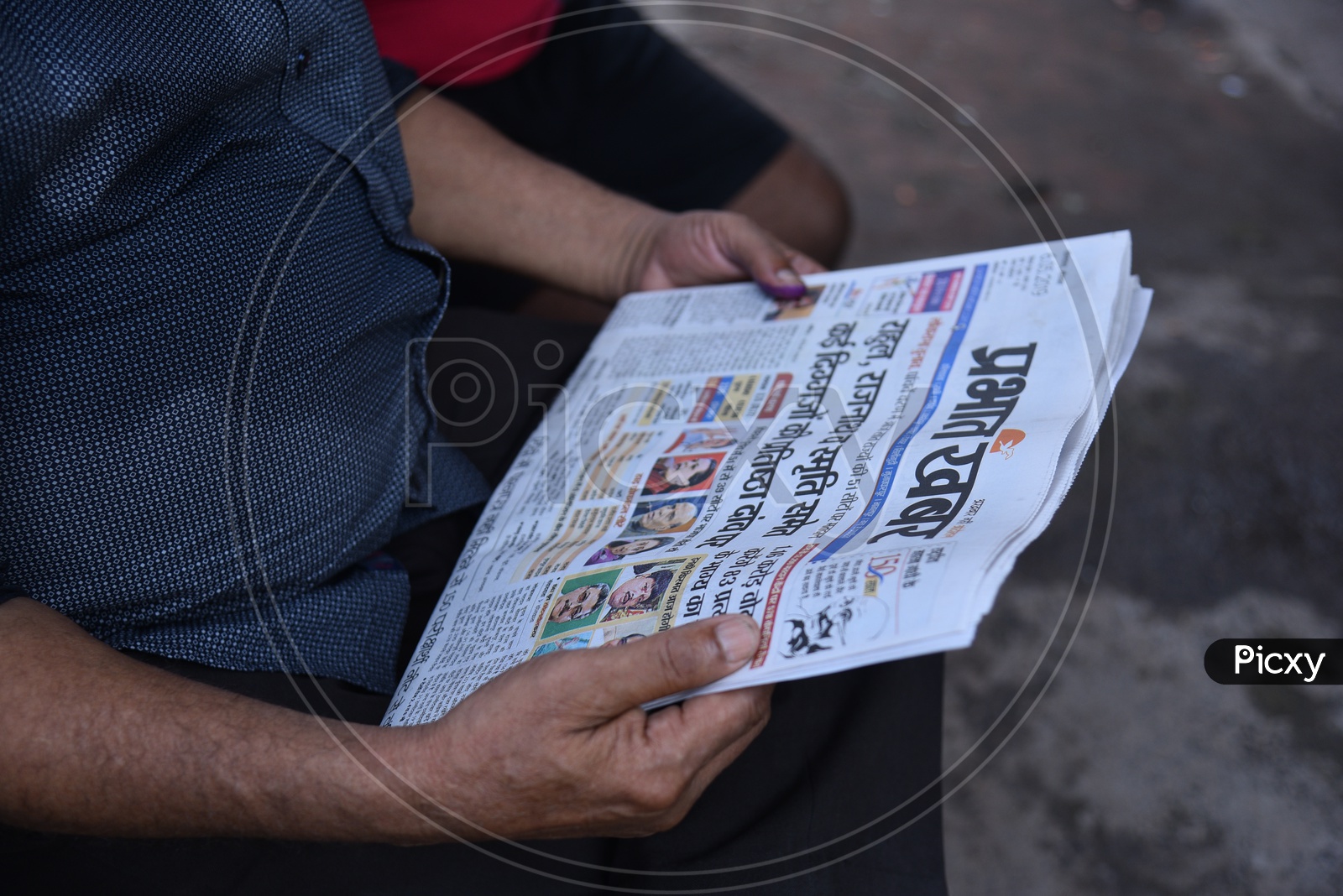 A Man Reading The Prabath Khabar News Paper In West Bengal