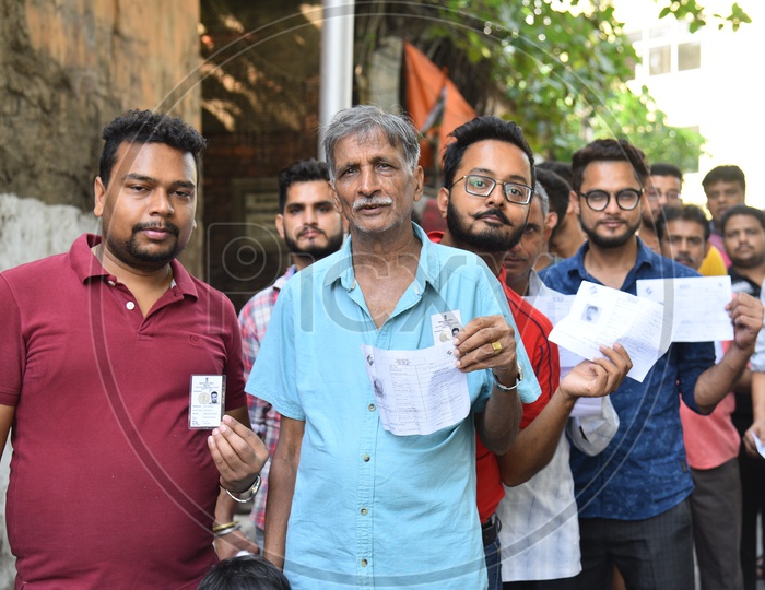 Voters Standing In Queue Lines and Showing EPIC Voter Cards  For Casting Their Votes In Lok Sabha  General Elections 2019  in West Bengal