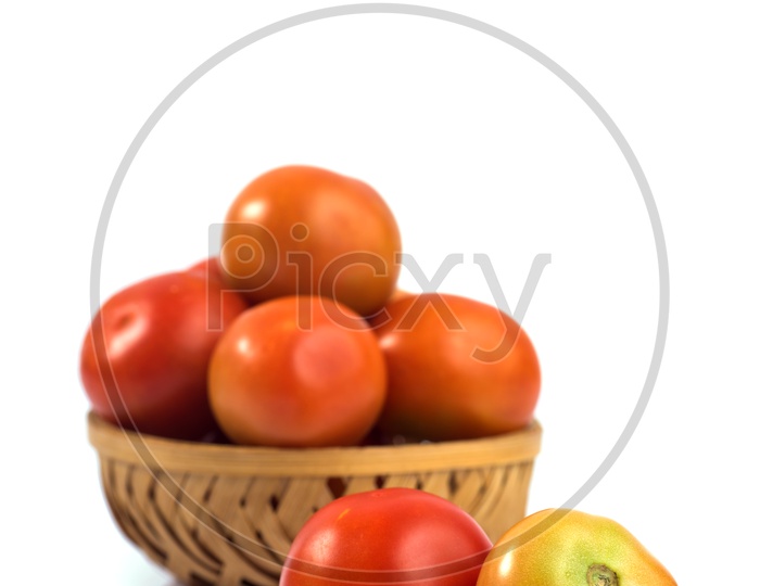 Fresh Red Tomatoes  Vegetable in a Wooden Weaved Basket On an Isolated White Background