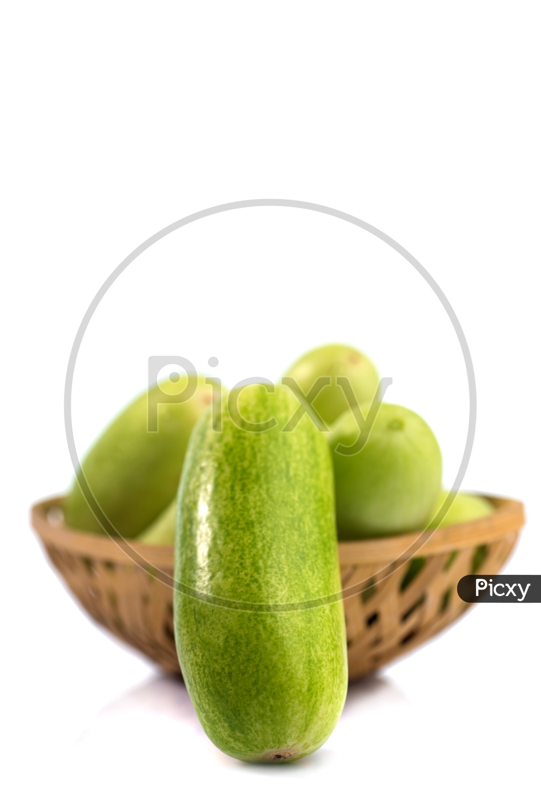 Fresh Green Cucumber Vegetable in a Wooden Weaved Basket On an Isolated White Background