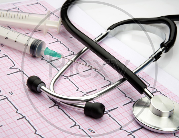 Stethoscope with cardiogram and syringe