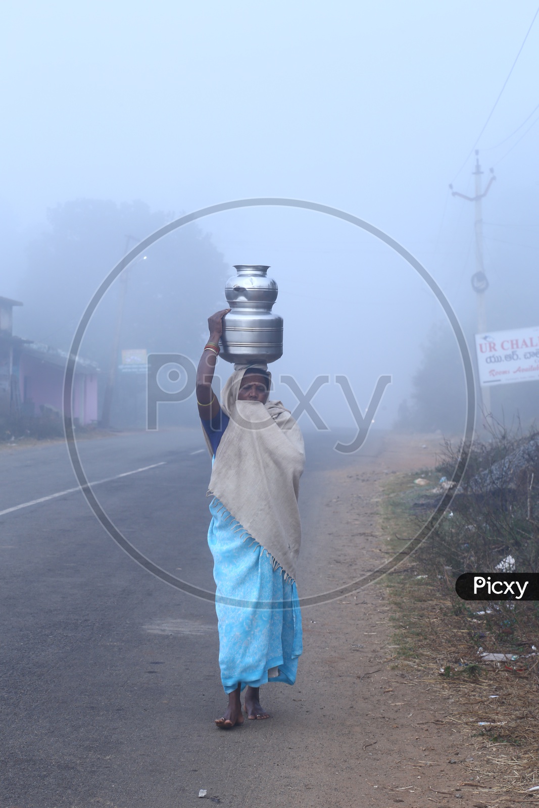 Tribals. Woman carrying water in Araku tribal area during winter.