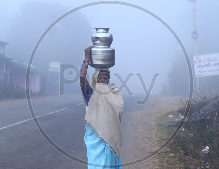 Tribals. Woman carrying water in Araku tribal area during winter.
