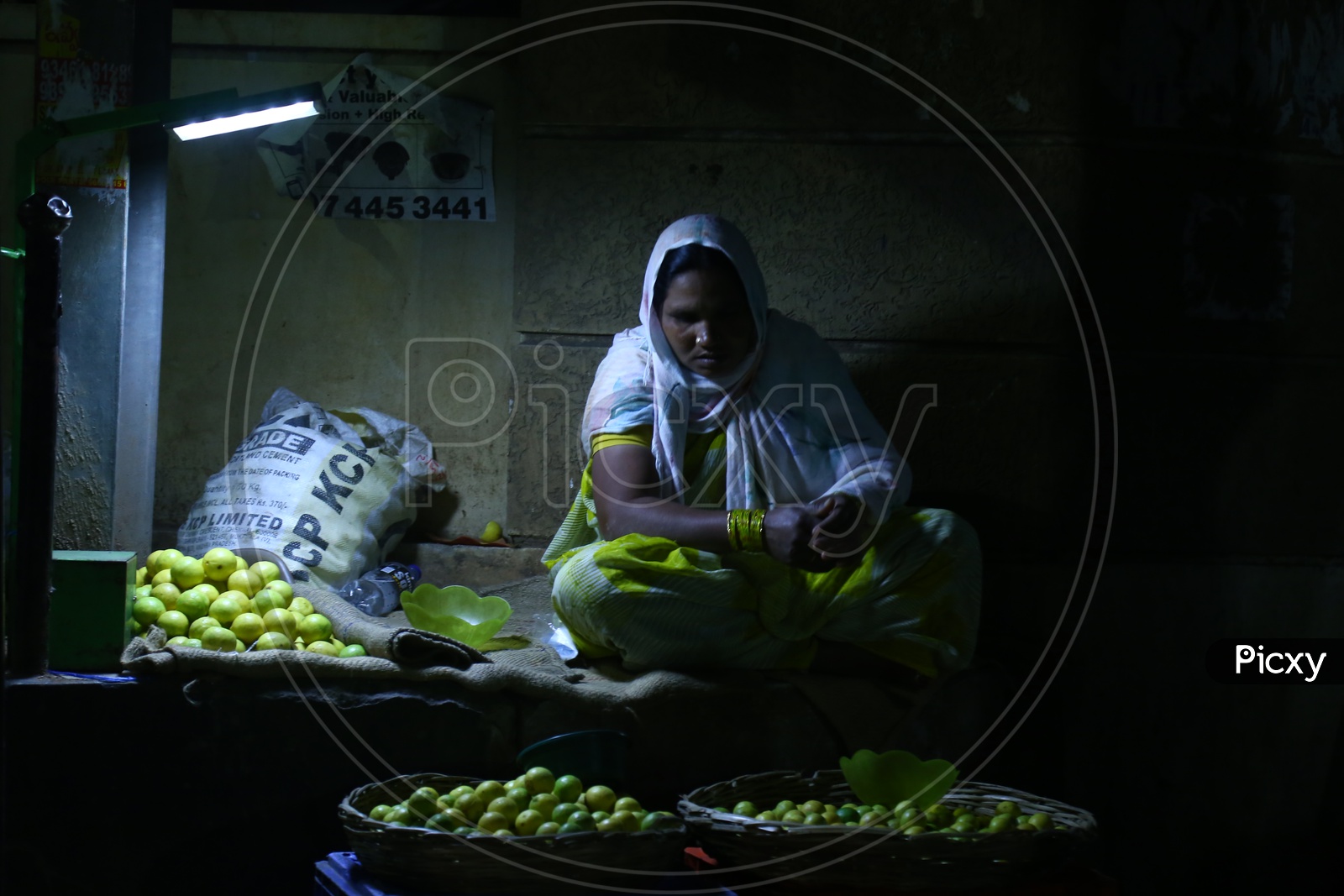 Woman Selling Lemons in Market