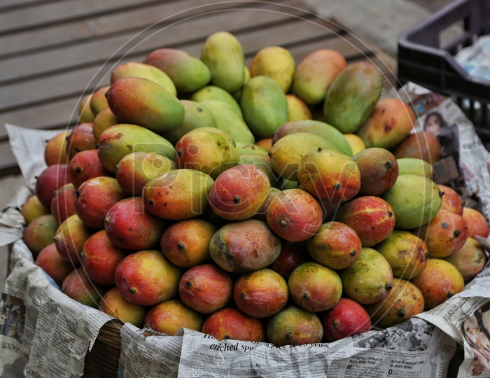 Fresh Mangoes In a Basket  At a Fruit Vendor Stall