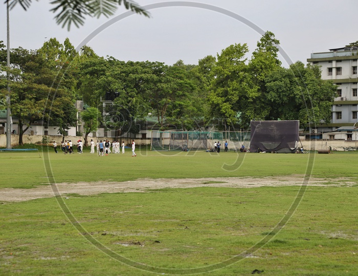 A Cricket Stadium  With Players Practicing
