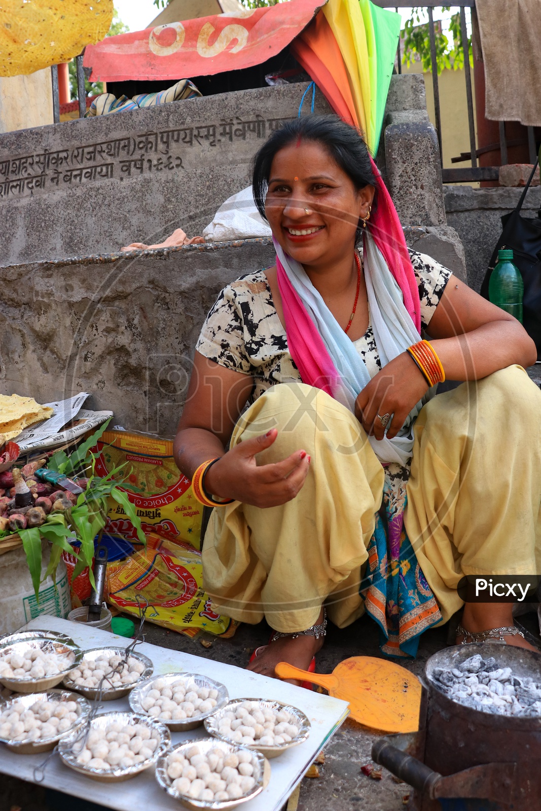 Smiling woman street vendor selling food