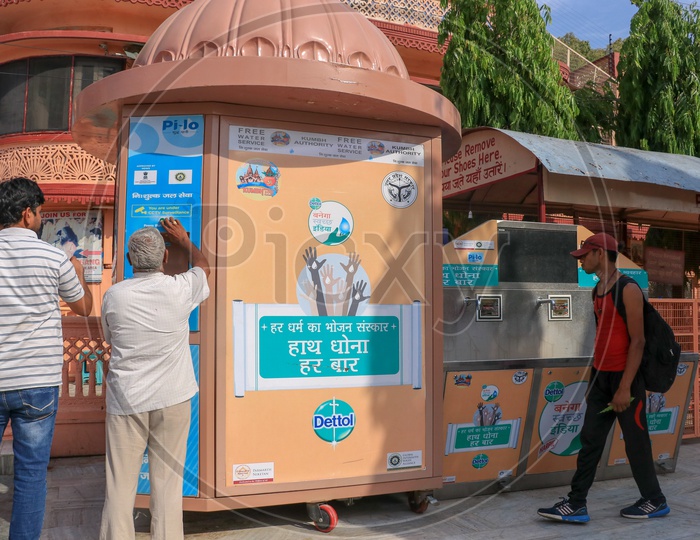 Tourists filling drinking water at free water service by Kumbh authority
