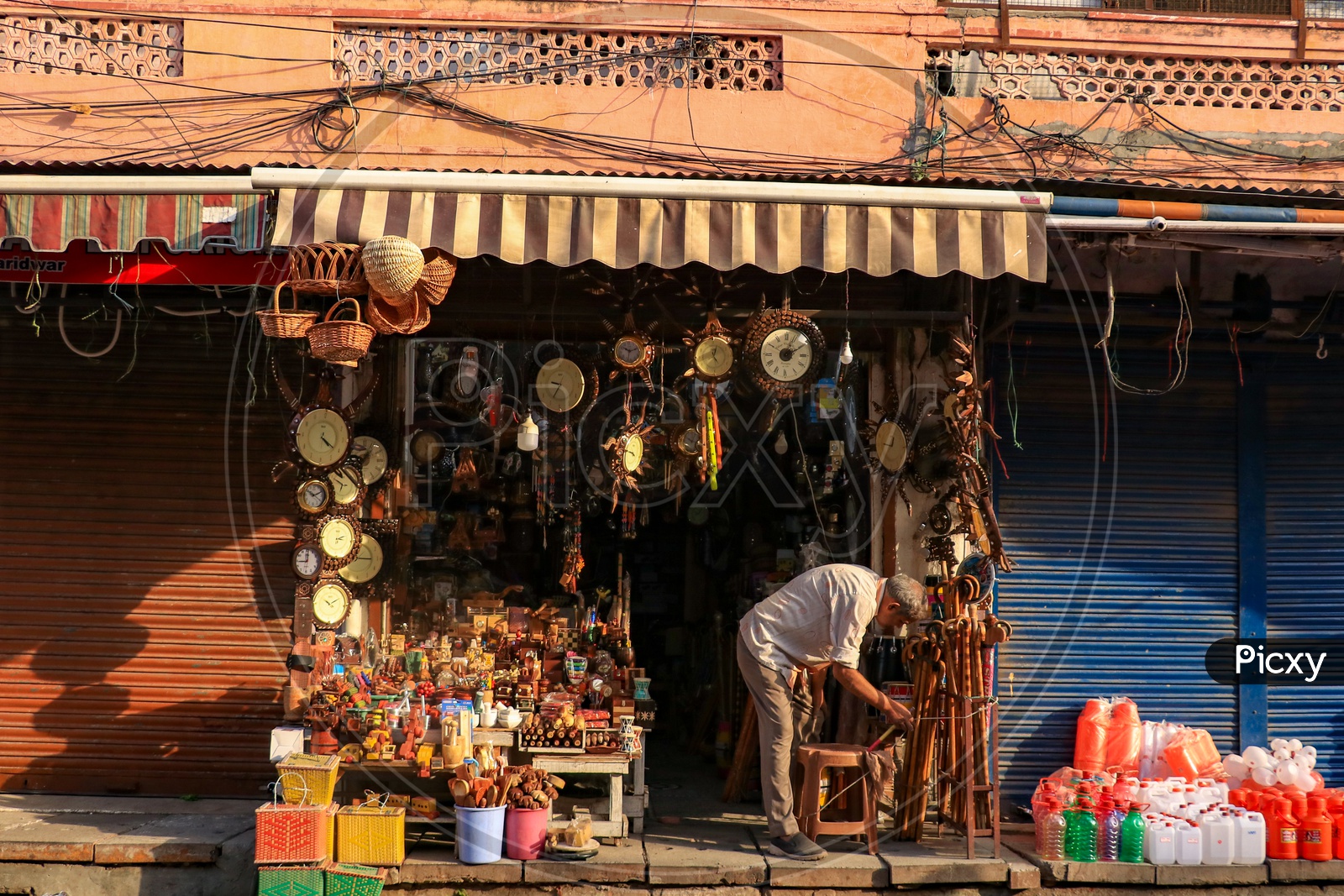 A shop owner setting up his shop in the morning