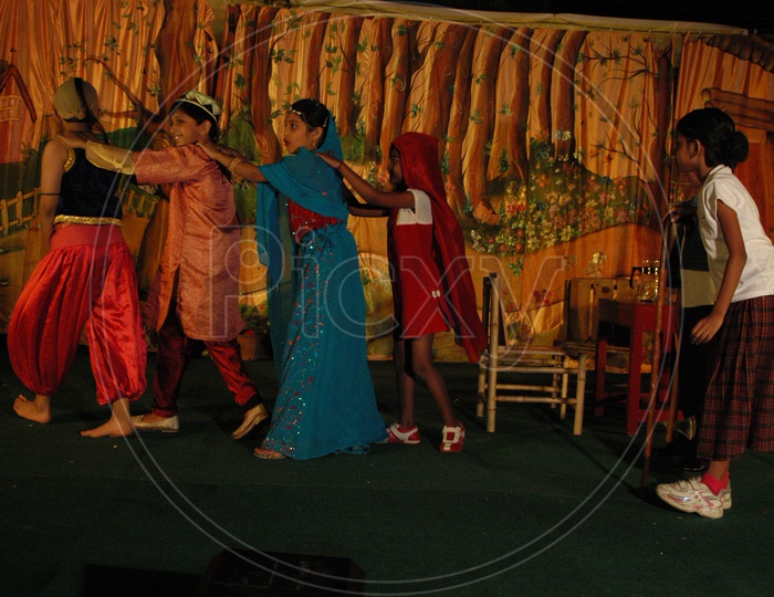Children Or School Students  Performing On Stage  Wearing Fancy Dresses  in a Annual Day  Concert
