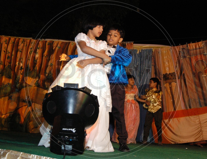Children Or School Students  Performing On Stage  Wearing Fancy Dresses  in a Annual Day  Concert