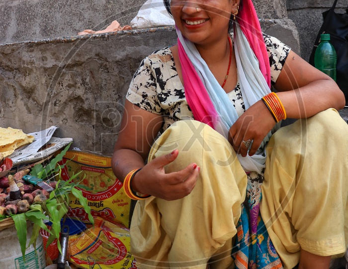 Smiling woman street vendor selling food