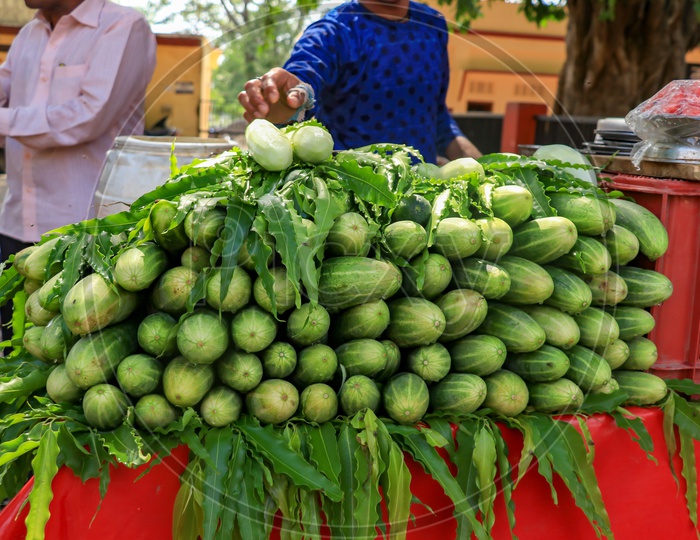 Street vendor selling cucumber on a hot sunny day