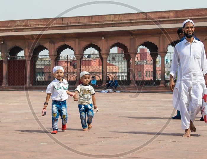 Brothers holding hands and their father on the day of Eid-ul-Fitr (End of the holy month of Ramadan) at Jama Masjid, Delhi
