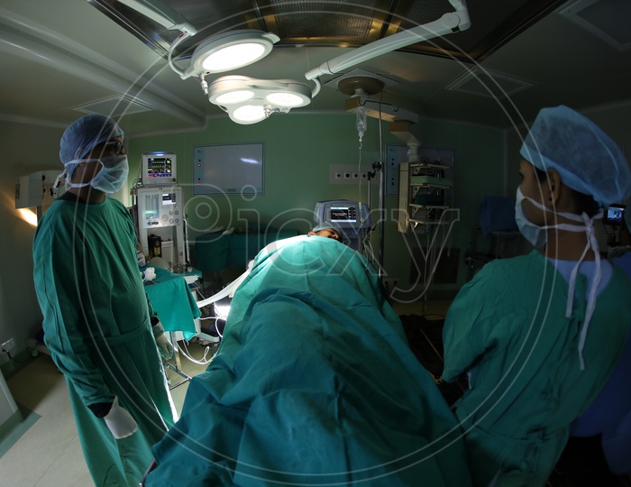 Doctor Treating Patient In Operation Theater or  ICU  in a  Hospital