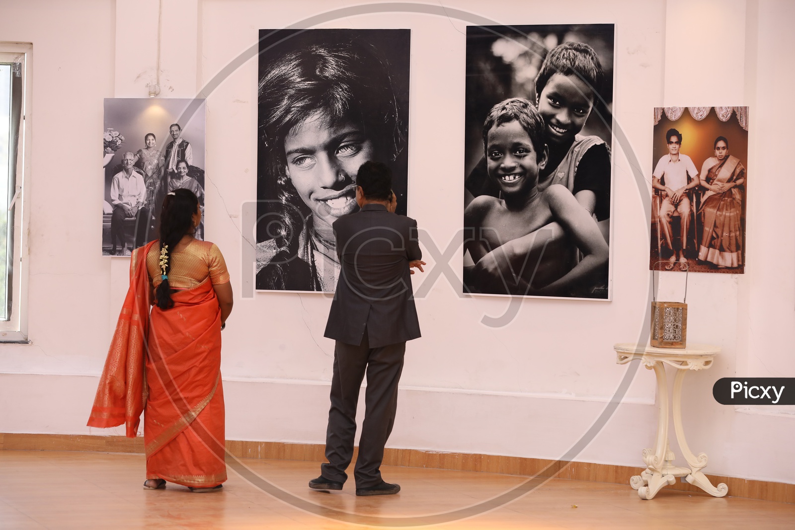 Visitors watching The Photographs in an Art Gallery