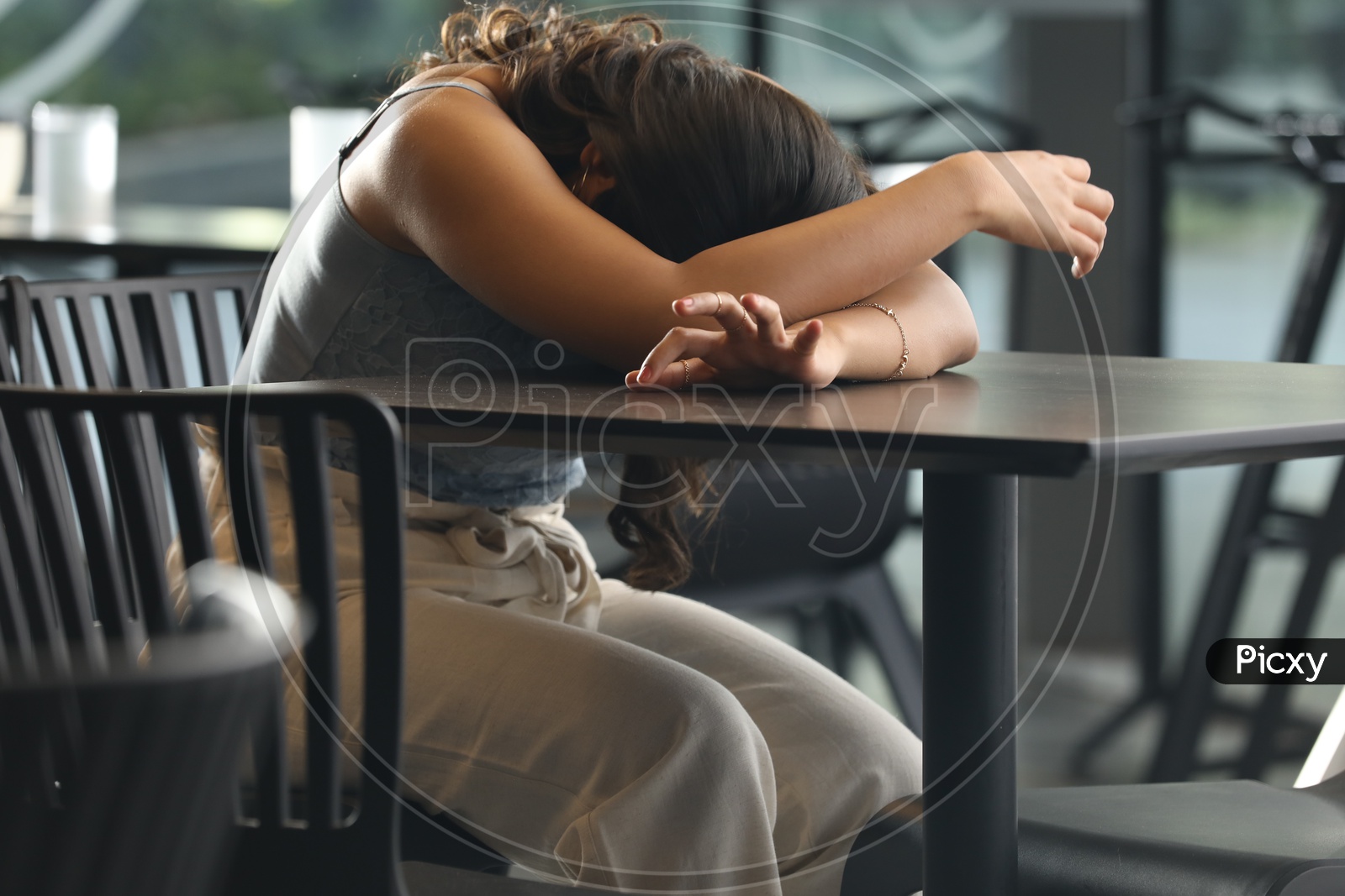 Image Of Young Girl Lying Head On Table Or Unhappy Or Uneasy Girl Sleeping By Putting Head On A