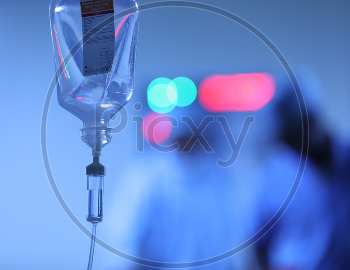 Saline Bottle or Pouch Hanging To a Stand in a  Hospital Ward