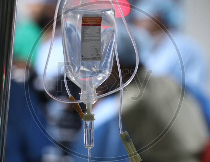 Saline Bottle Or Pouch Hanging To a Stand In a  Hospital Ward