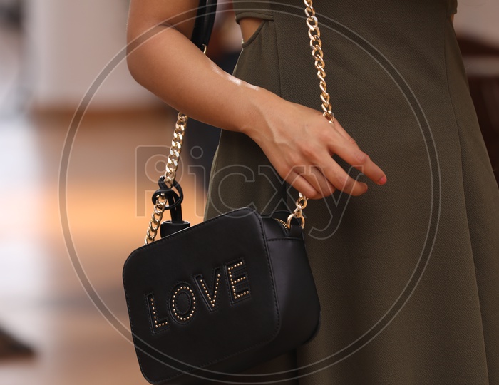 Pretty Woman With a Sling Bag Or Hand Bag Hanging To her Shoulder Closeup